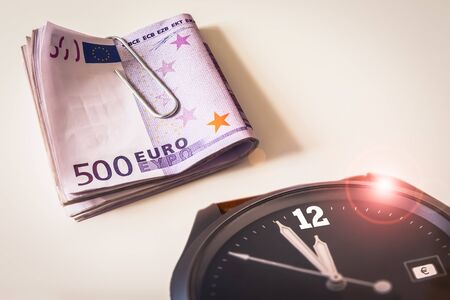 Wrist Watch with a Bundle of Five Hundred Euro Banknotesの写真素材