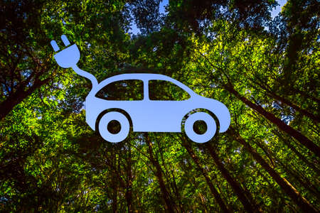 View into the Canopy of a Forest Combined with the Shape of an Electric Car, Cable and Plugの写真素材
