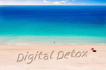 The Words Digital Detox written on a Sunny Beachの写真素材