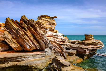 Rocky coastline against ocean and blue skyの写真素材