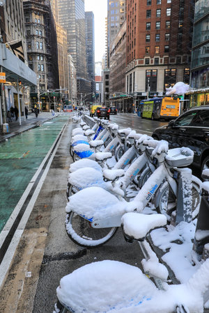Bicycles covered with snow in Lower Manhattan in New York City. Bicycles are the most popular means of transportation in the city.の写真素材