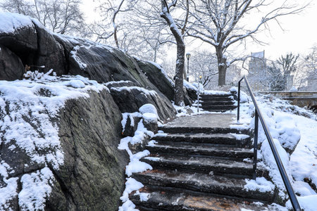 Stone stairs in Central Park covered with snow in winter, New York City, USAの写真素材