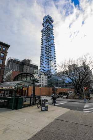 View of underground subway entrance and city skyscrapers in Manhattan, New York.