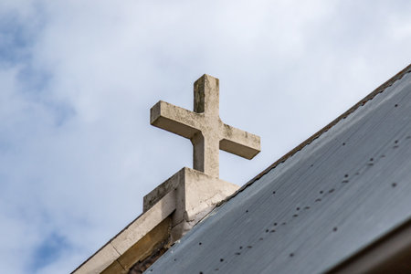 View of an old church in a rural setting, surrounded by farmland and natural scenery. Rustic heritage architecture in a peaceful countryside landscapeの写真素材