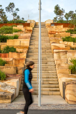 Woman walking through a Sydney city street scene showing buildings, streetscape, and urban...