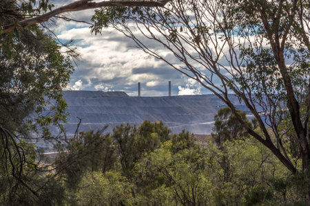 Industrial landscape highlighting open-cut mining operations under a wide Australian sky.