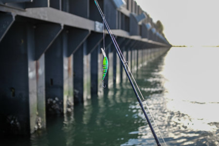 Fishing rod with reel on the background of the fishing pier.の写真素材