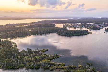 A breathtaking aerial view of the Mid North Coast of New South Wales, showcasing turquoise ocean waters, white sandy beaches, and the bridge linking Forster and Tuncurryの写真素材