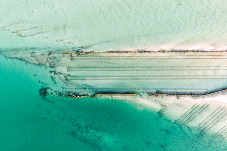 A breathtaking aerial view of Forster on the Mid North Coast of New South Wales, showcasing turquoise ocean waters, white sandy beaches, and the bridge linking Forster and Tuncurryの写真素材