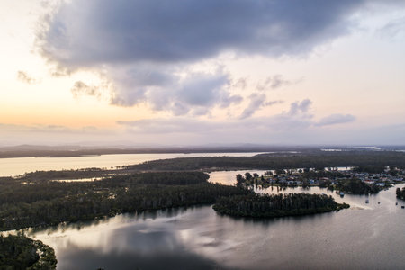 A breathtaking aerial view showcasing turquoise ocean waters, white sandy beaches, and the bridge linking two towns.の写真素材