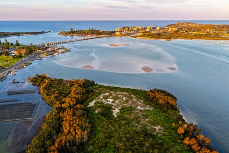 A breathtaking aerial view of Forster on the Mid North Coast of New South Wales, showcasing turquoise ocean waters, white sandy beaches, and the bridge linking Forster and Tuncurryの写真素材