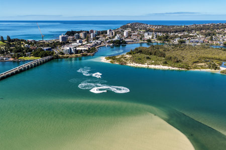 A breathtaking aerial view of Forster on the Mid North Coast of New South Wales, showcasing turquoise ocean waters, white sandy beaches, and the bridge linking Forster and Tuncurryの写真素材