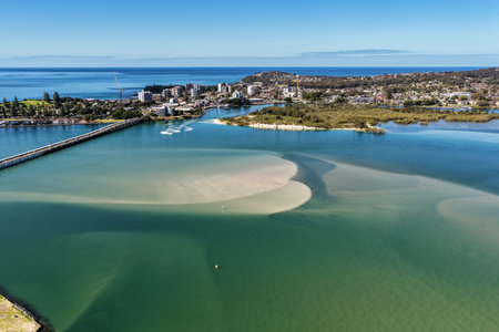A breathtaking aerial view of Forster on the Mid North Coast of New South Wales, showcasing turquoise ocean waters, white sandy beaches, and the bridge linking Forster and Tuncurryの写真素材