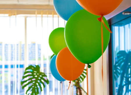 Colorful baloons in office space against window.の写真素材