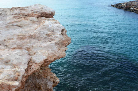 Granite sand colored cliff in Mediterranean Sea.