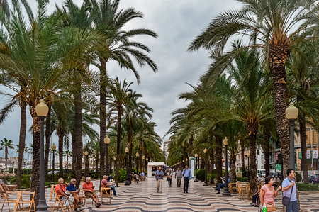 Alicante, Spain - September, 29, 2015: Promenade Explanada - main famous landmark street in Alicante along embankment with wave tiles in autumn overcast weather.のeditorial素材