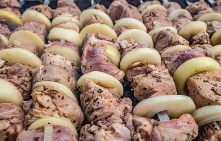 Raw pork kebab meat on metal skewers.の写真素材