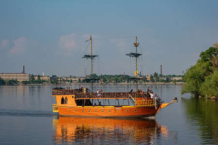 Dnipro, Ukraine - May 26, 2021: Tourists on pirate ship decorating in old-fashioned style sailing on Dnipro river.のeditorial素材