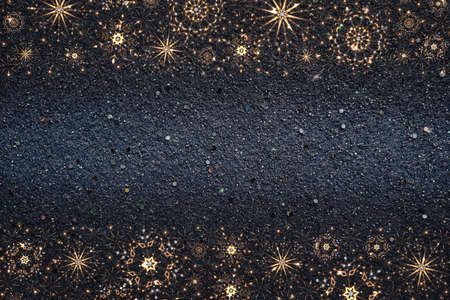 Christmas illustration with falling sparkling yellow neon snowflake borders on blue glittering felt...
