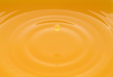the waves after a few drops of orange juice.の写真素材