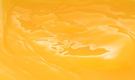 the waves after a few drops of orange juice.の写真素材