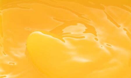 the waves after a few drops of orange juice.の写真素材