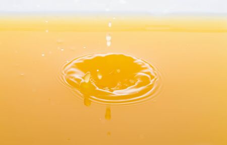 the waves after a few drops of orange juice.の写真素材
