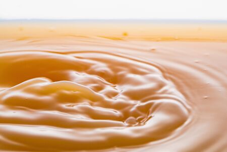 rippling after a few drops of peach juice.の写真素材