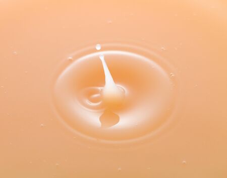 rippling after a few drops of peach juice.の写真素材