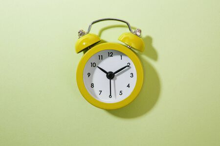 Yellow background and alarm clock