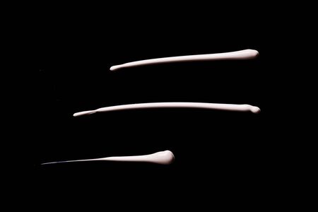 the texture of a foundation liquid. Black background.の写真素材