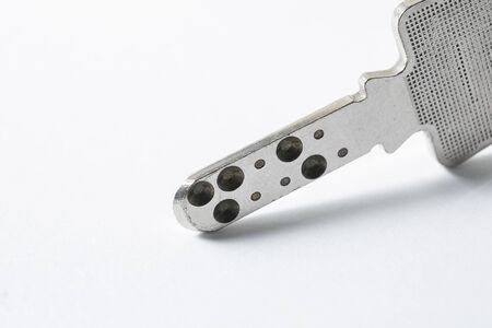 Close up of Silver key on white background