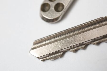 Close up of Silver key on white background