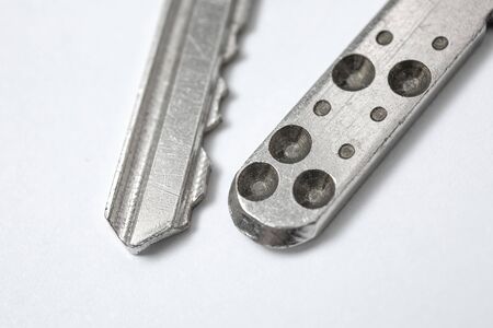 Close up of Silver key on white backgroundの写真素材