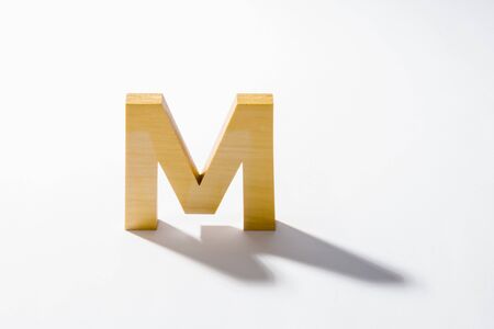 Wooden Alphabet M and Shadow Reflection.の写真素材