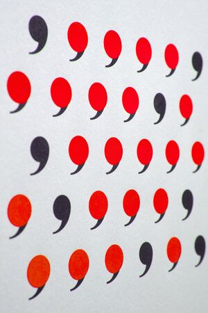 black comma in many red commas.の写真素材