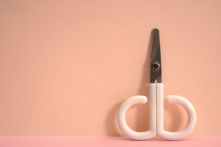 Pink color background and cute little scissors.の写真素材