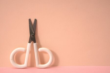 Pink color background and cute little scissors.