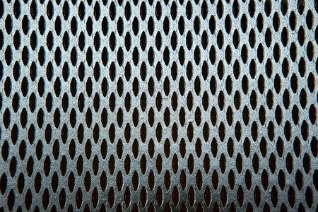 The texture and pattern of perforated metal.の写真素材