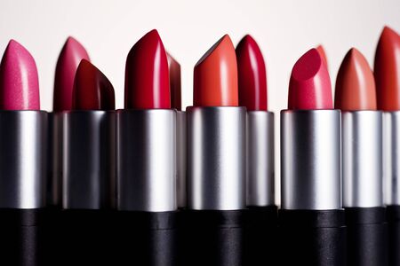 any of various colored lipstick in a case made of black plastic and steel.の写真素材