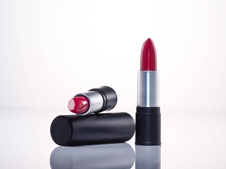 any of various colored lipstick in a case made of black plastic and steel.の写真素材