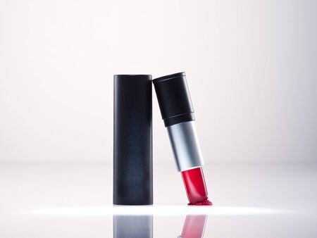 any of various colored lipstick in a case made of black plastic and steel.の写真素材
