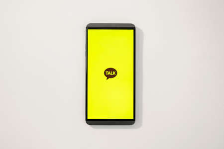 Message app KAKAO TALK logo on smartphone screen.