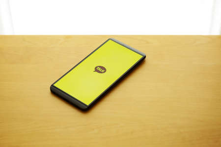 Message app KAKAO TALK logo on smartphone screen.のeditorial素材