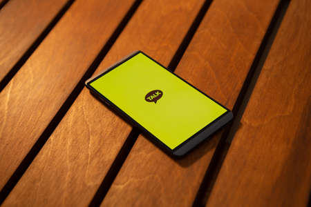 Message app KAKAO TALK logo on smartphone screen.のeditorial素材