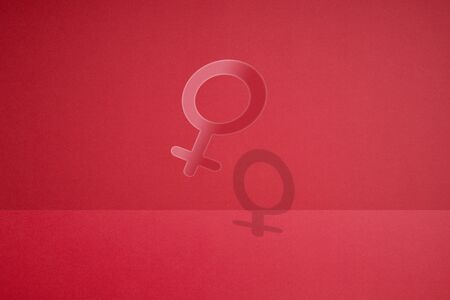 a female gender symbol made by cutting paper.の写真素材