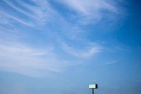 a blue sky and a small plane that can be seen far away.の写真素材