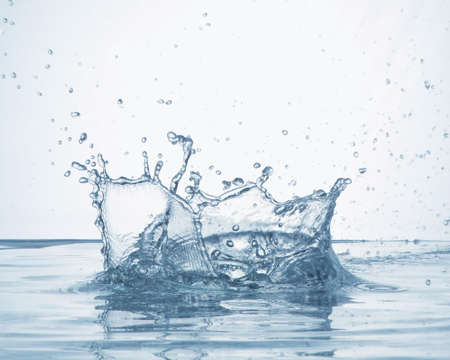 a scene in which drops of water splash after dropping an object in the water.の写真素材