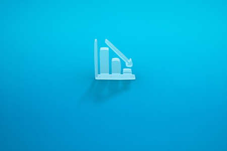a falling graph on a blue background. a falling arrow. 3D rendering.の写真素材