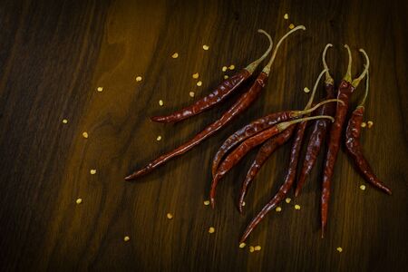 Composition of dried guajillo chili with seeds on wooden tableの写真素材